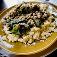 Spiced cous cous topped with lentils and wilted swiss chard